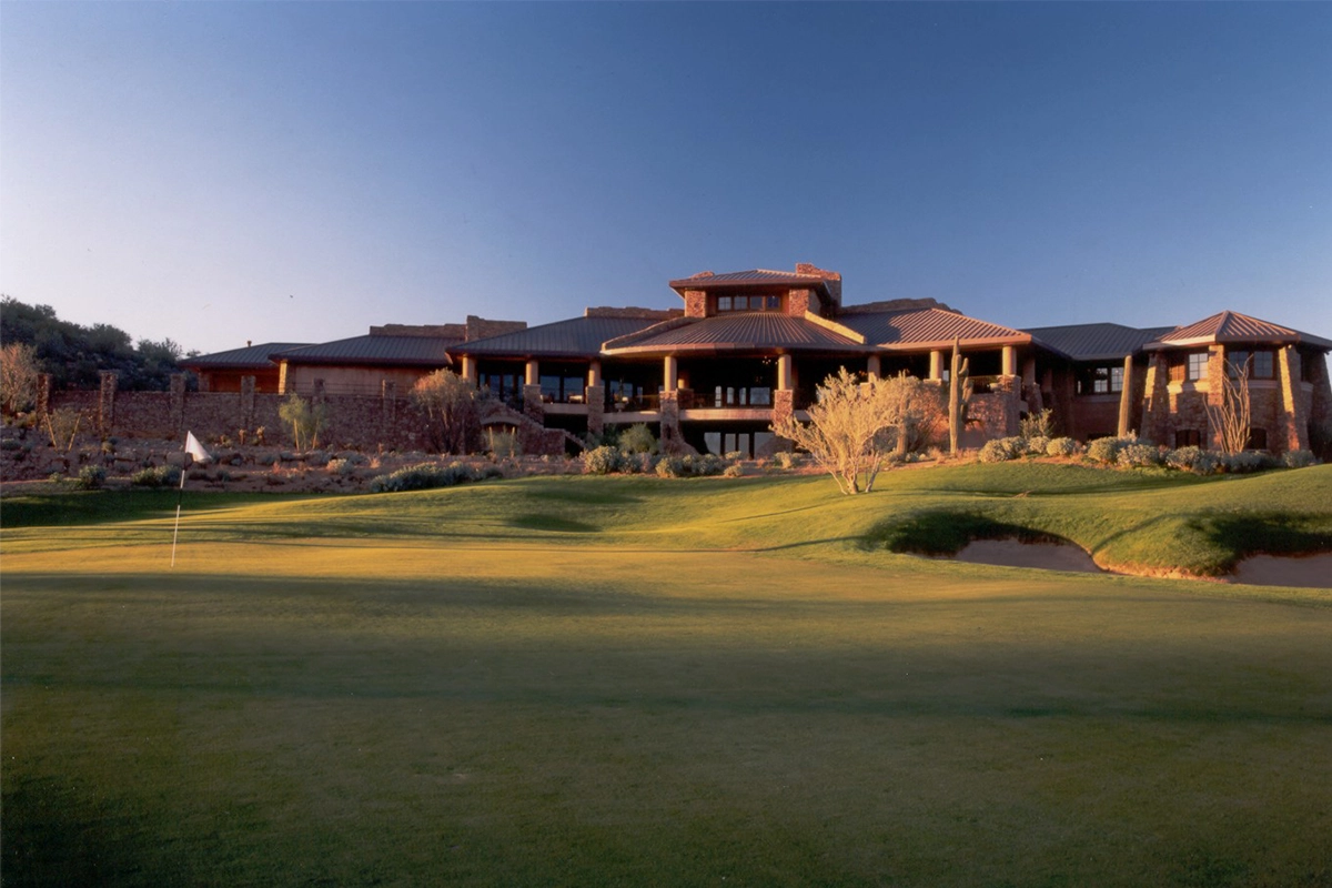 Fire Rock Country Club clubhouse at sunset with championship golf course green and desert mountain views showcasing Arizona golf architecture