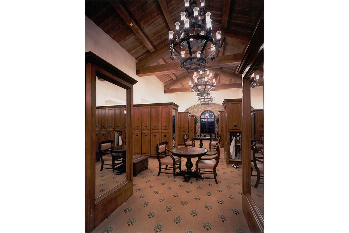 Luxury members locker room at The Bridges featuring custom wood lockers, exposed beam ceilings and wrought iron chandeliers