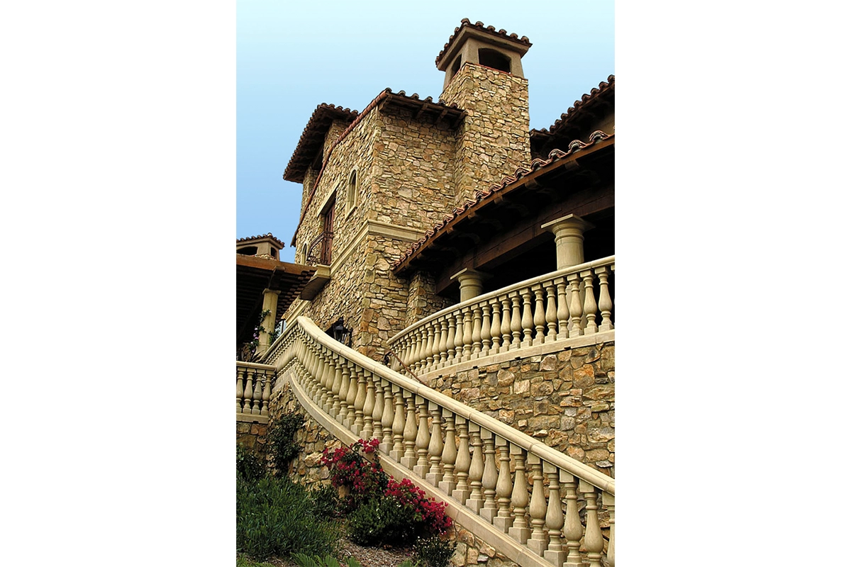 Stone tower and curved balustrade staircase showcasing authentic Tuscan architecture at The Bridges at Rancho Santa Fe luxury club